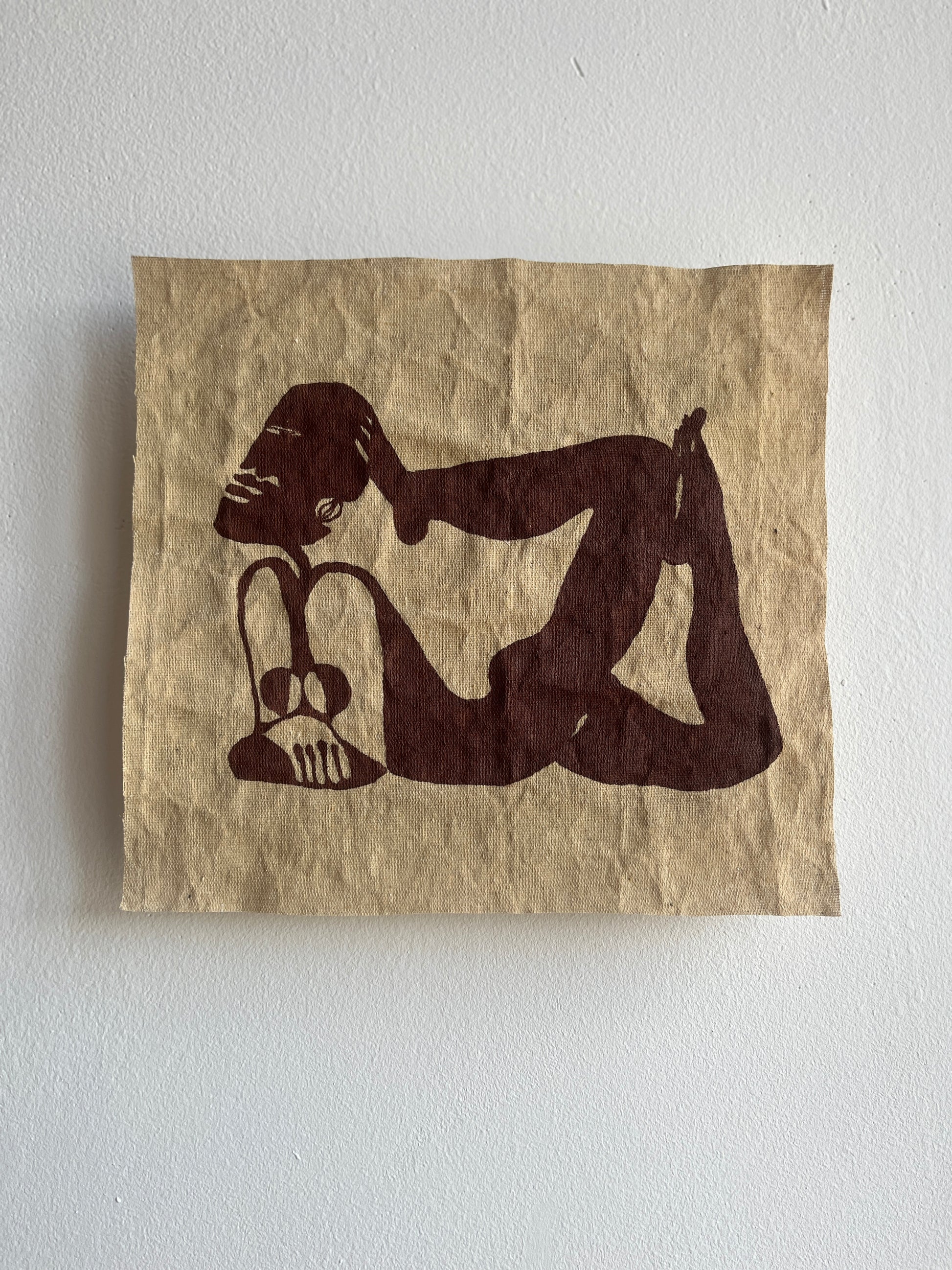 Raw canvas with a stylized illustration of a nude figure on a plain background