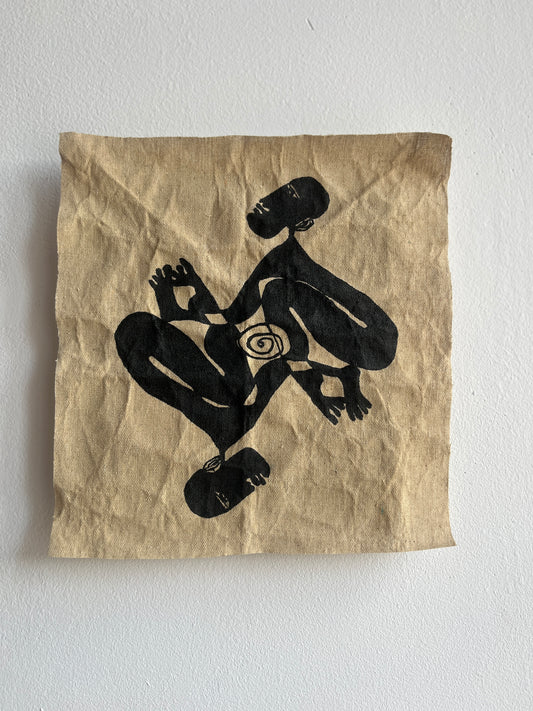 Textile with black silhouette of a person and a spiral on a beige background