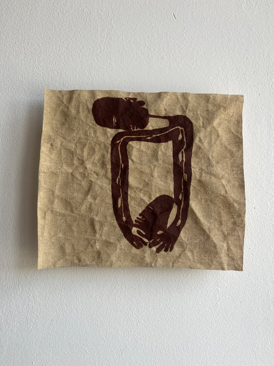 Abstract painting on a crumpled textile against a white wall