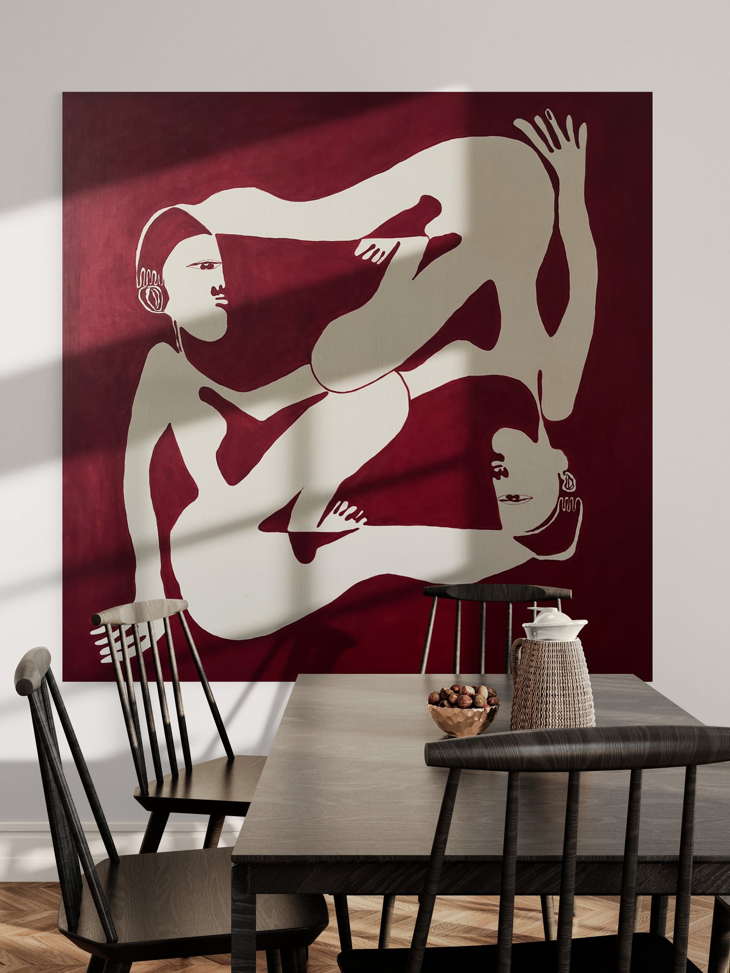 Dining room with a large abstract artwork of two nude figures on a red background.