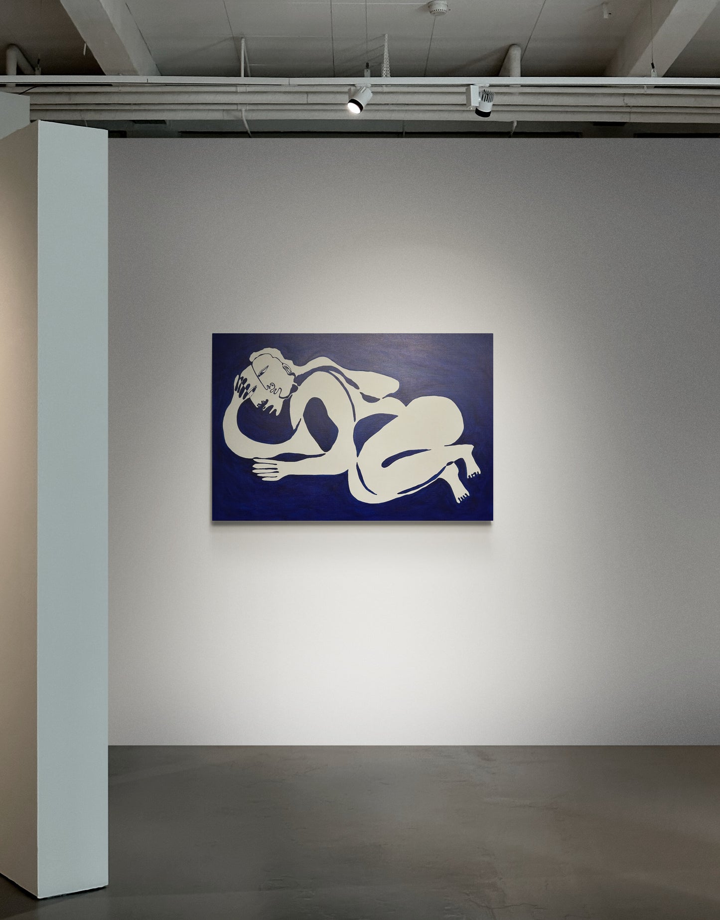 Abstract artwork of nude figures on a blue background in an art gallery.