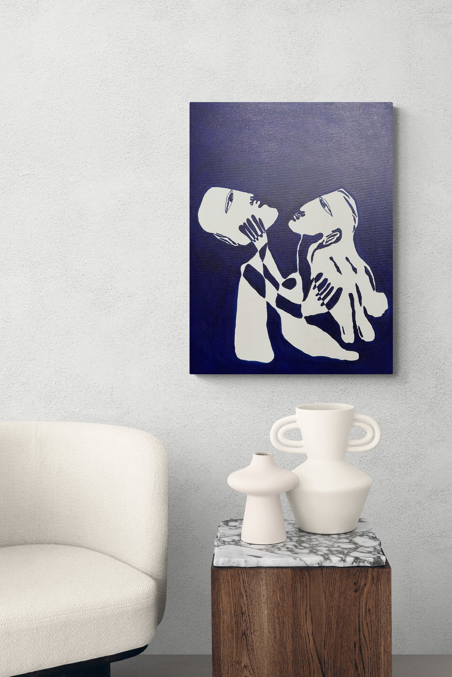 Abstract artwork of a couple embracing on a dark blue background, displayed in a modern living room.