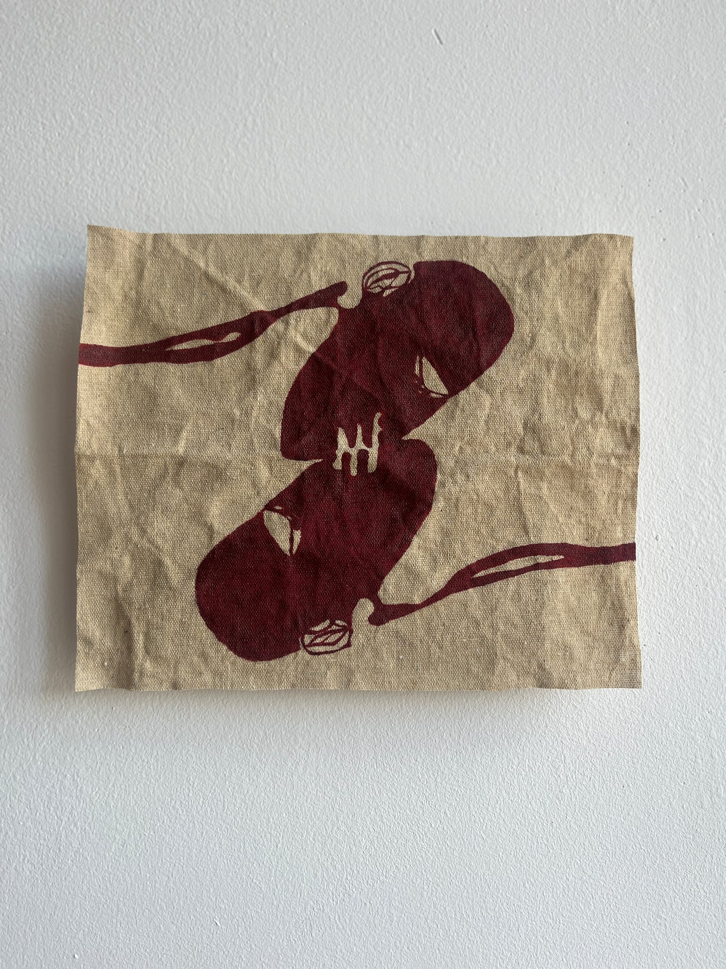 Natural canvas with an abstract design on a white wall